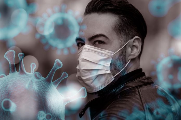 covid-19_coronavirus_battling-virus-with-surgical-mask_by-recep-bg-getty-images_1210129671_virus-cells_by-jongho-shin-getty-images-1208691882-100835999-large